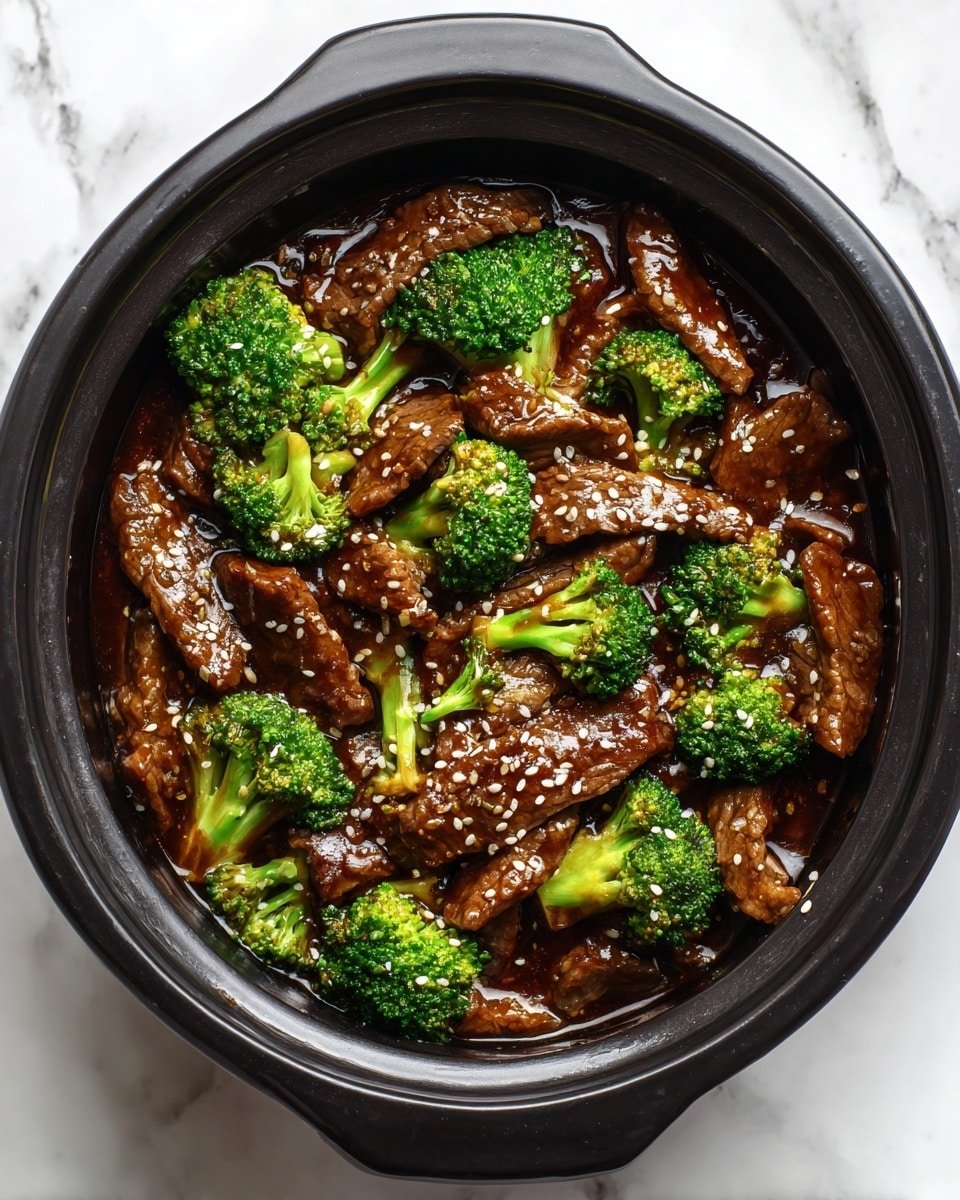 The image shows a black pot filled with dark brown sauce layered with tender brown beef slices and bright green broccoli florets scattered on top. The sauce looks glossy and thick, with small white sesame seeds sprinkled over the beef and broccoli. The pot sits on a white marbled surface, giving a clean, fresh look to the scene. photo taken with an iphone --ar 4:5 --v 7 — Keto Beef and Broccoli, keto beef stir-fry, low carb beef broccoli, healthy keto dinner, easy keto recipes